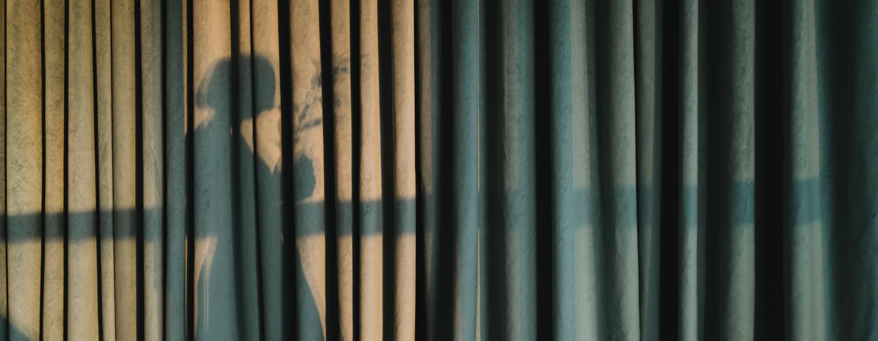silhouette of a woman on a curtain